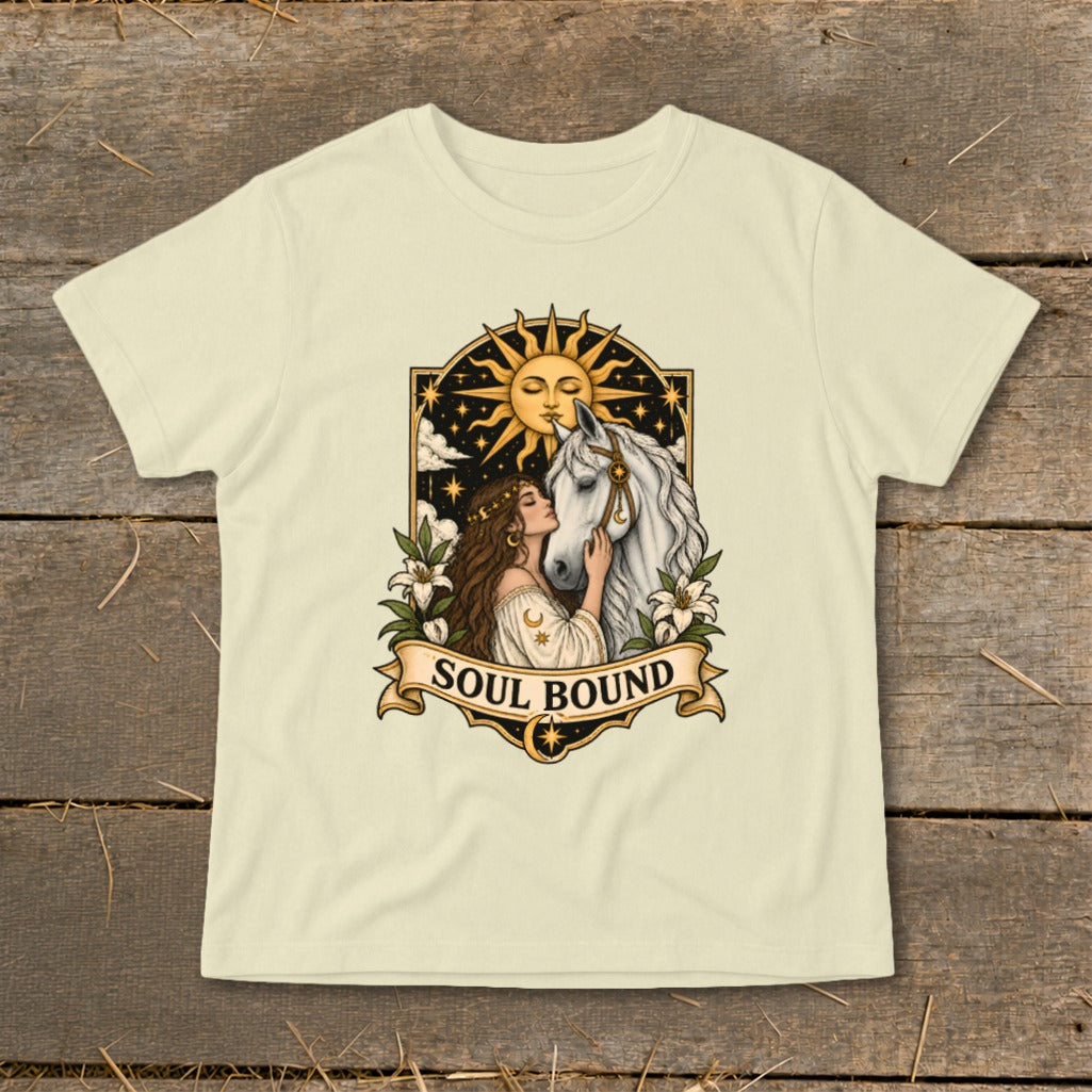 Cream t-shirt with woman kissing white horse, sun, stars, and banner text "SOUL BOUND".