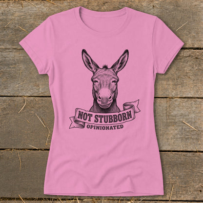Pink t-shirt with a donkey illustration and text "NOT STUBBORN OPINIONATED".