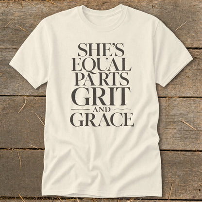 Cream t-shirt with black text that reads "SHE'S EQUAL PARTS GRIT AND GRACE".