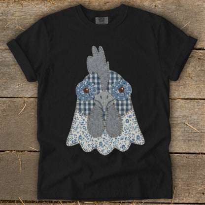 Black t-shirt with a blue and white fabric chicken head applique.