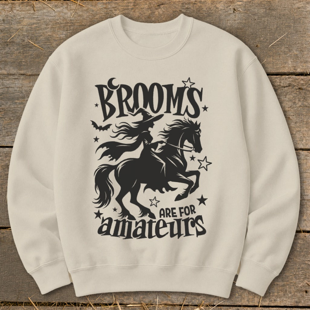 Black silhouette of a witch on a horse with text "BROOMS ARE FOR amateurs".