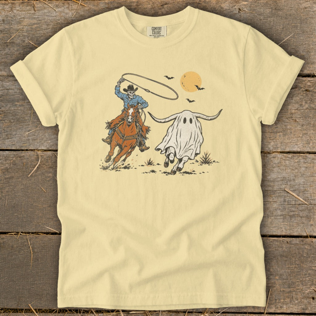 Skeleton cowboy on horse lassoing a running ghost with bull horns and moon.