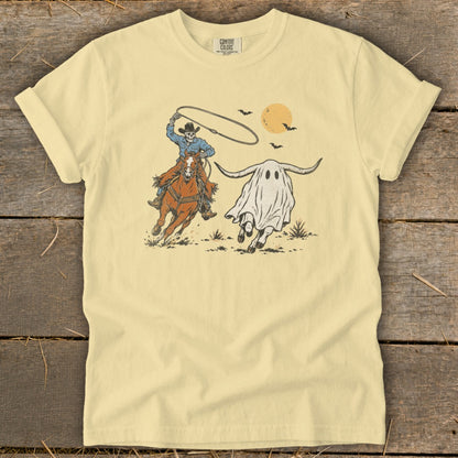 Skeleton cowboy on horse lassoing a running ghost with bull horns and moon.