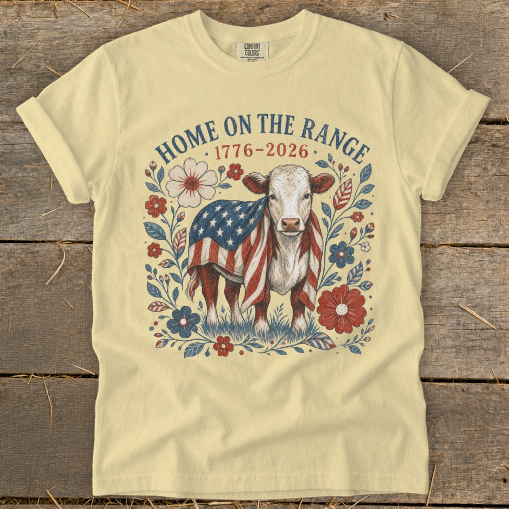 Cow draped in an American flag surrounded by floral design and text, "HOME ON THE RANGE 1776-2026."