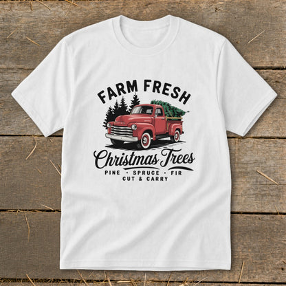 White t-shirt with a red truck carrying a Christmas tree and the text "Farm Fresh Christmas Trees."