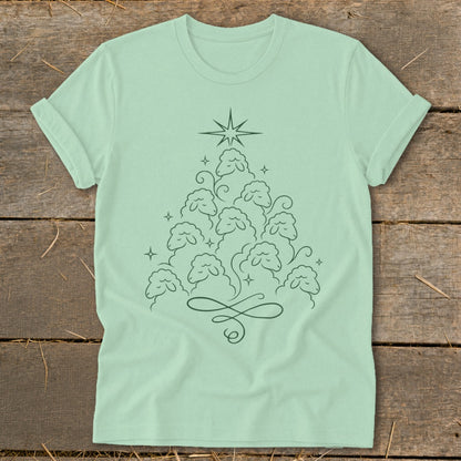 Light green t-shirt with a line drawing of a Christmas tree made of sheep and a star.