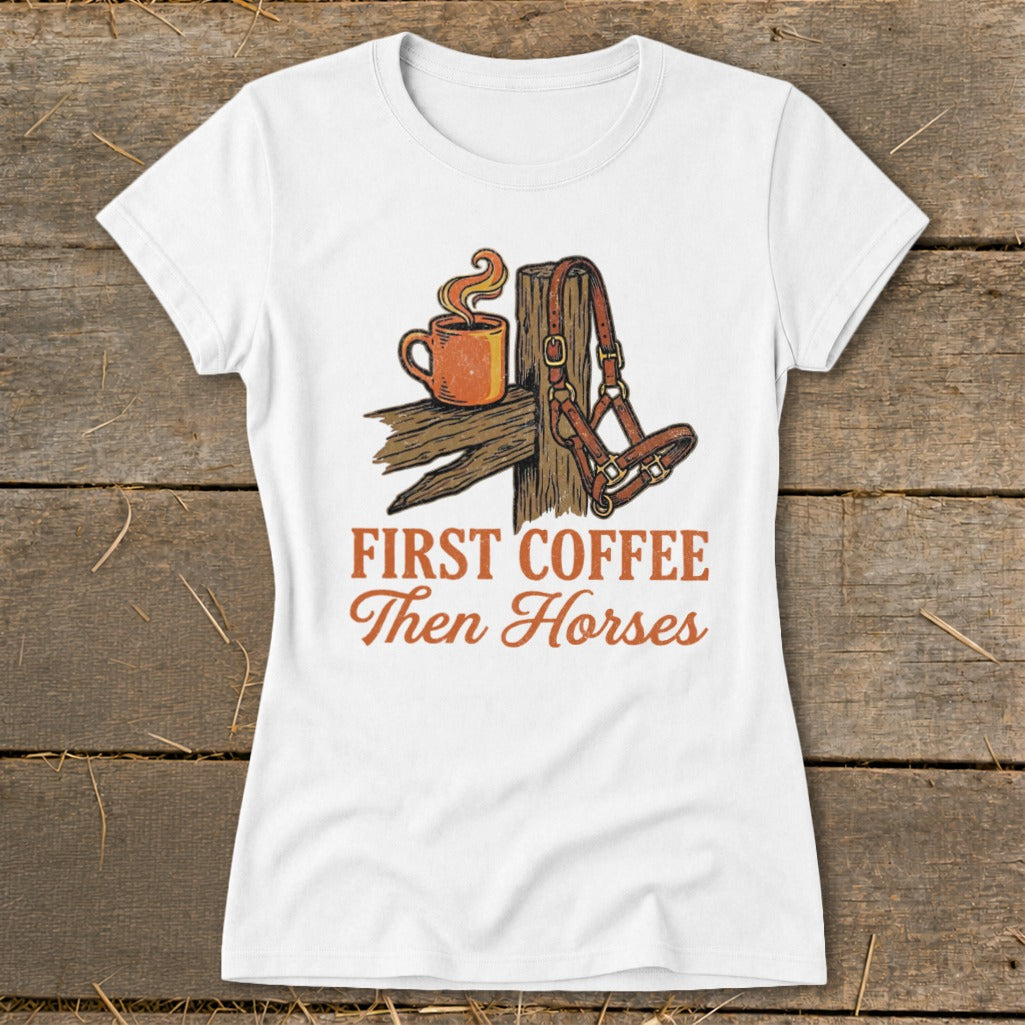 White t-shirt with "First Coffee Then Horses" text and graphic of coffee cup and horse halter.