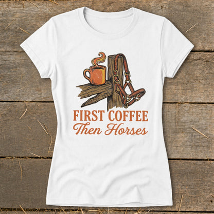 White t-shirt with "First Coffee Then Horses" text and graphic of coffee cup and horse halter.