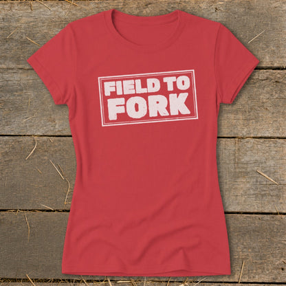 A red short-sleeved t-shirt with white stamped text that reads "FIELD TO FORK".