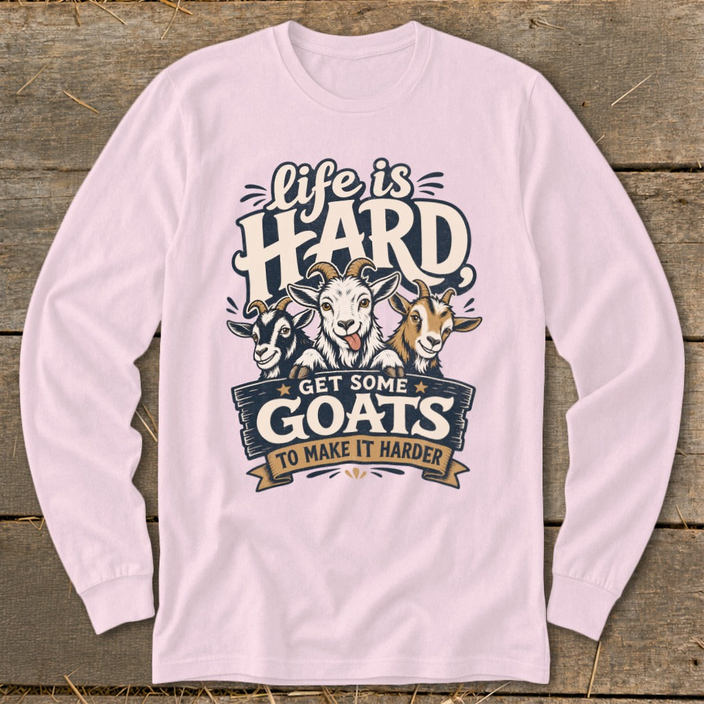 Pink long-sleeve shirt with a graphic featuring three goats and text "Life is HARD GET SOME GOATS TO MAKE IT HARDER".