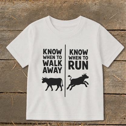 White t-shirt with text "KNOW WHEN TO WALK AWAY" and a walking cow.