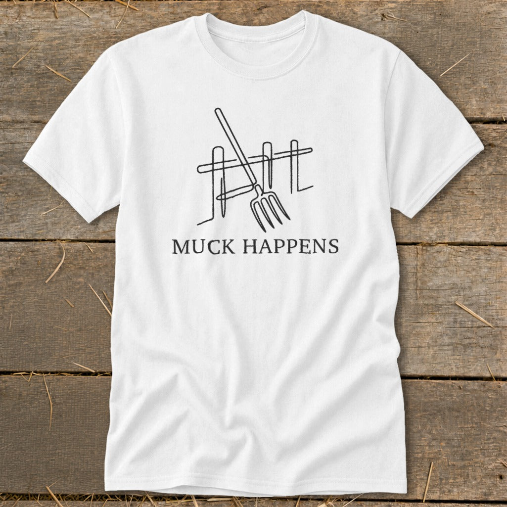 White t-shirt with a line drawing of a pitchfork and fence, and "MUCK HAPPENS" text.