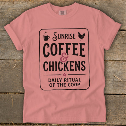 Pink t-shirt with "Sunrise Coffee & Chickens" graphic and text.