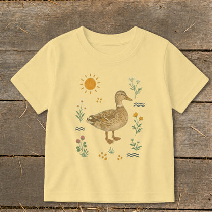 Yellow t-shirt with illustration of a mallard duck, sun, and wildflowers.