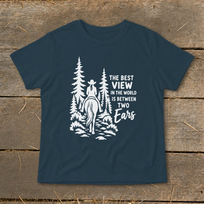 A dark blue t-shirt with a white graphic of a horseback rider and trees alongside text that reads, "The best view in the world is between two ears."