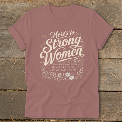 "Here's to Strong Women" text with decorative elements and floral accents.