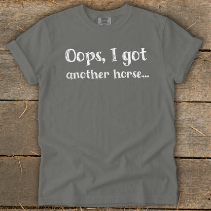 Gray t-shirt with white text reading "Oops, I got another horse..."