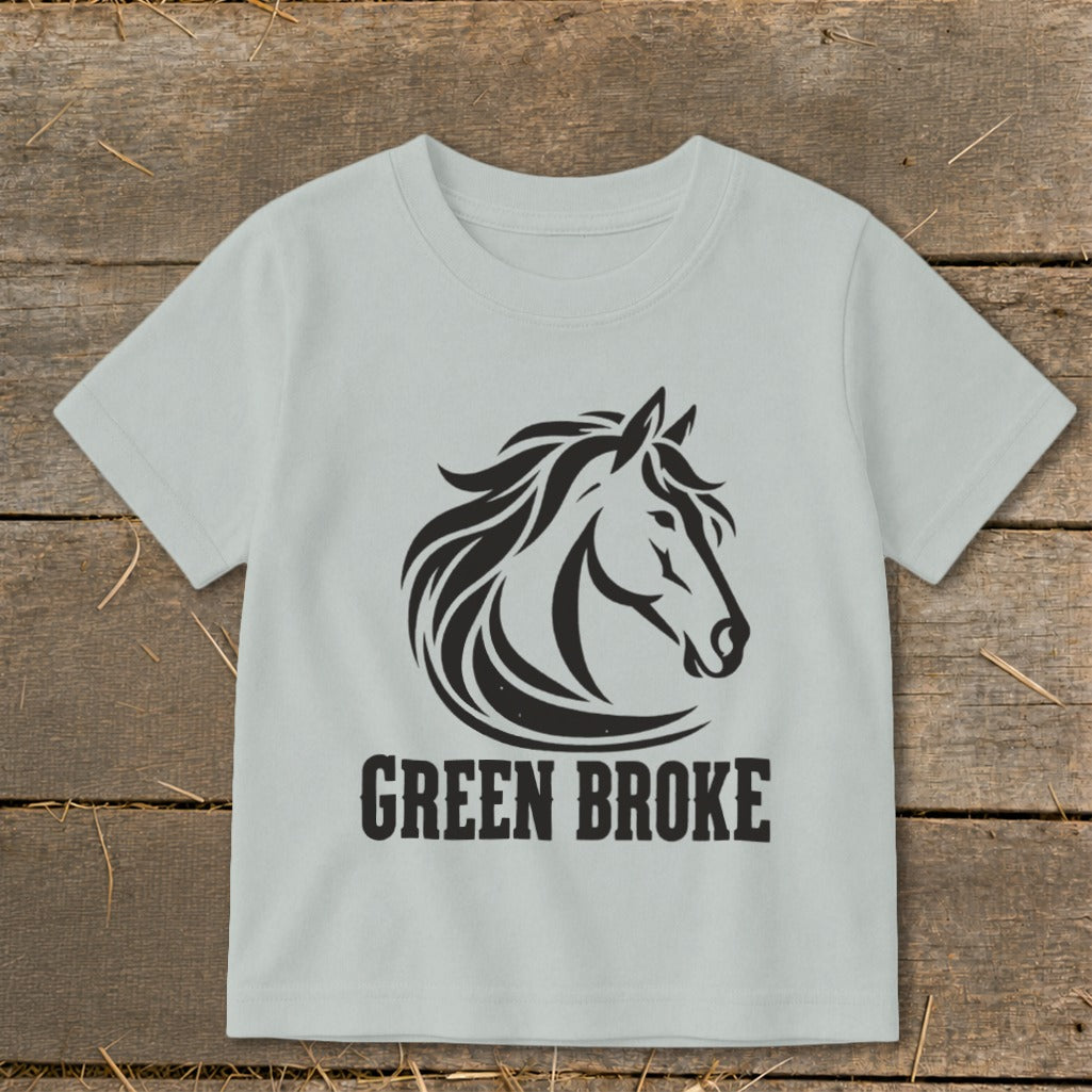 Light gray short-sleeve children's t-shirt featuring a black horse graphic and the text "GREEN BROKE".