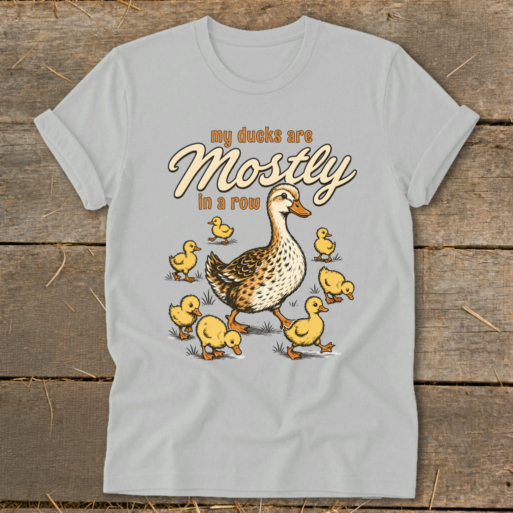 T-shirt graphic of a mother duck with ducklings, text reads "my ducks are Mostly in a row".