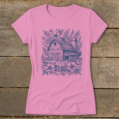 Pink t-shirt with a dark blue barn and floral line art design.