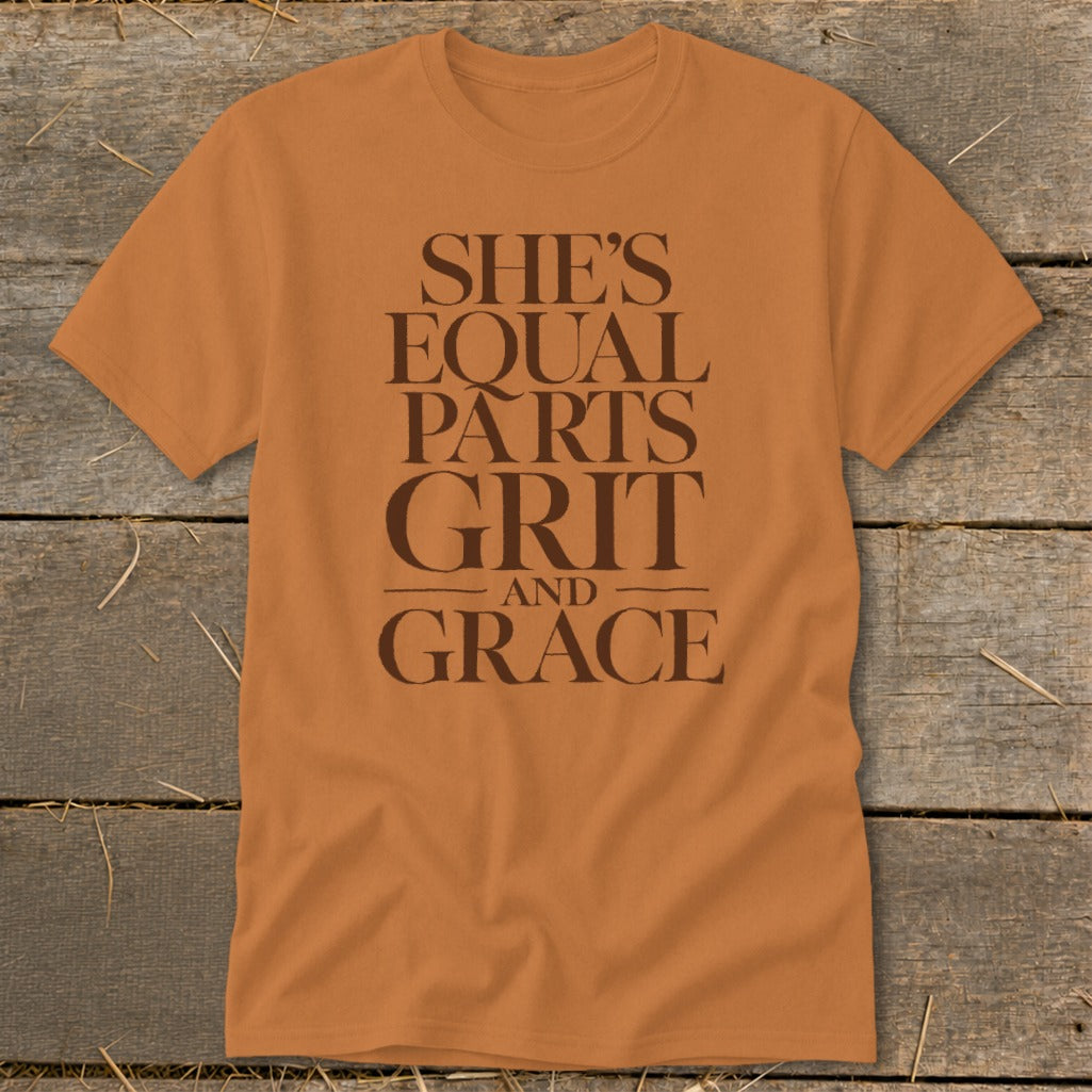 Orange t-shirt with "She's Equal Parts Grit And Grace" text in brown.