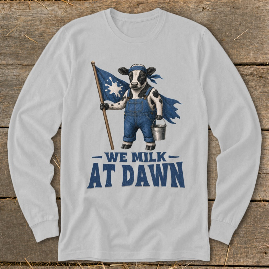 Cow in overalls with a cape and bucket holds a flag with text "WE MILK AT DAWN".