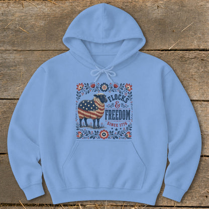 Light blue hoodie with a sheep decorated with American flag and text "Flocks & Freedom Since 1776".