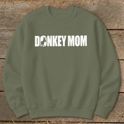 Olive green crewneck sweatshirt featuring white text that reads DONKEY MOM with a donkey silhouette inside the first letter O.