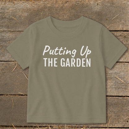 Olive green t-shirt with white text "Putting Up THE GARDEN"