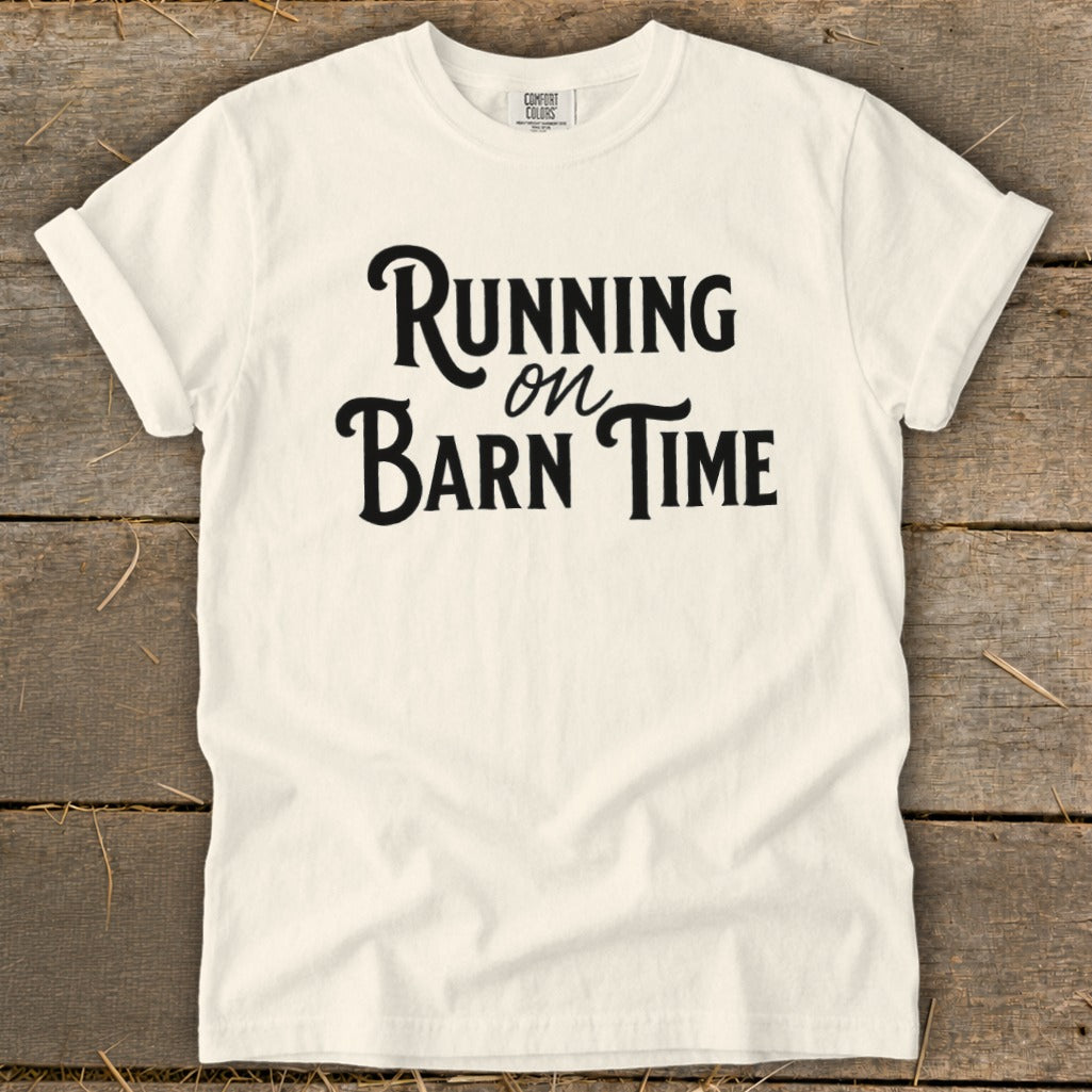 White t-shirt with black text "Running on Barn Time"