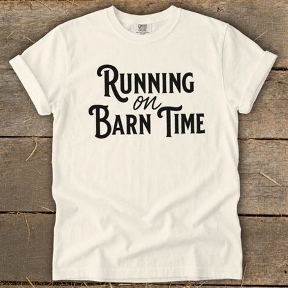 White t-shirt with black text "Running on Barn Time"