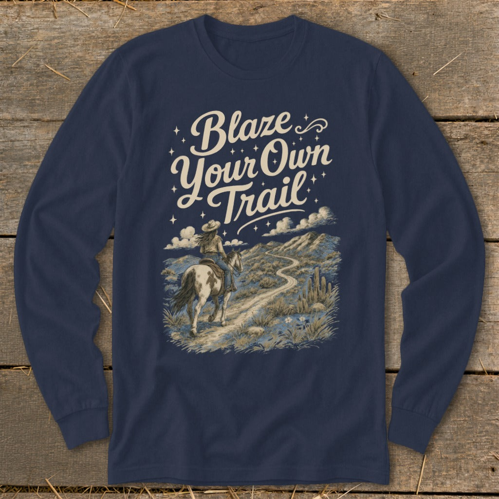 Navy long-sleeve shirt with "Blaze Your Own Trail" and a woman riding a horse through a desert landscape.