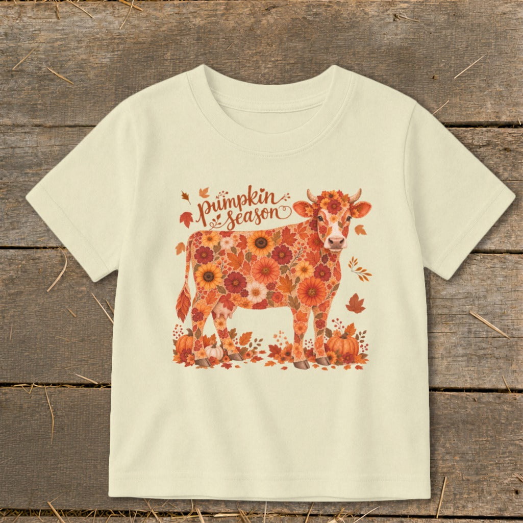 Cream t-shirt with a cow made of orange and red flowers and "pumpkin season" text.