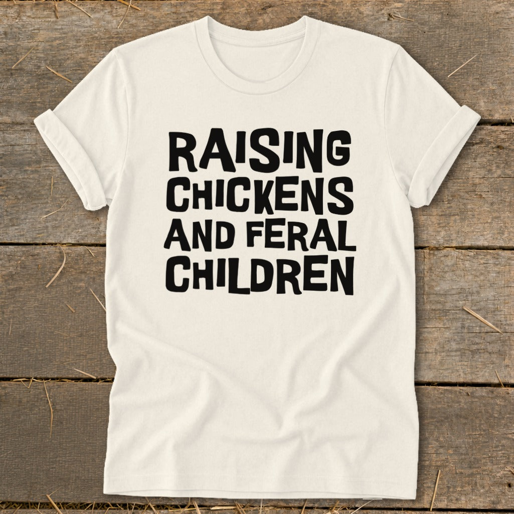 Cream t-shirt with black text "RAISING CHICKENS AND FERAL CHILDREN"