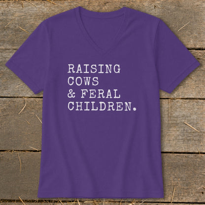 Purple v-neck t-shirt with white text "RAISING COWS & FERAL CHILDREN."