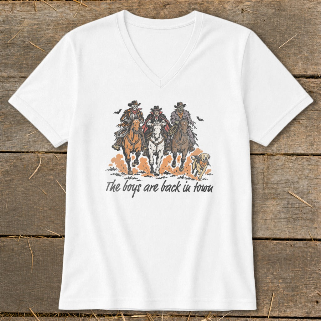 White t-shirt graphic with skeleton cowboys and vampire riding horses and dog, text "The boys are back in town."