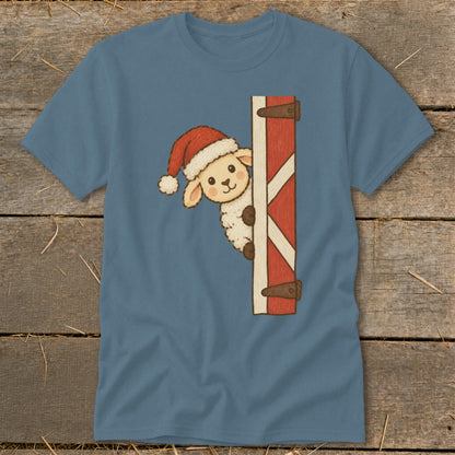 Sheep wearing Santa hat peeking around red barn door graphic on blue t-shirt.