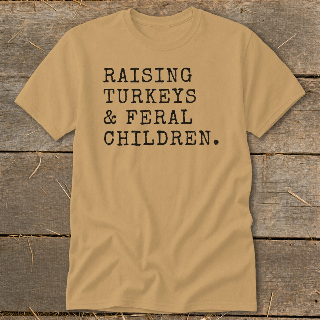 Tan t-shirt with black text reading "Raising Turkeys & Feral Children."
