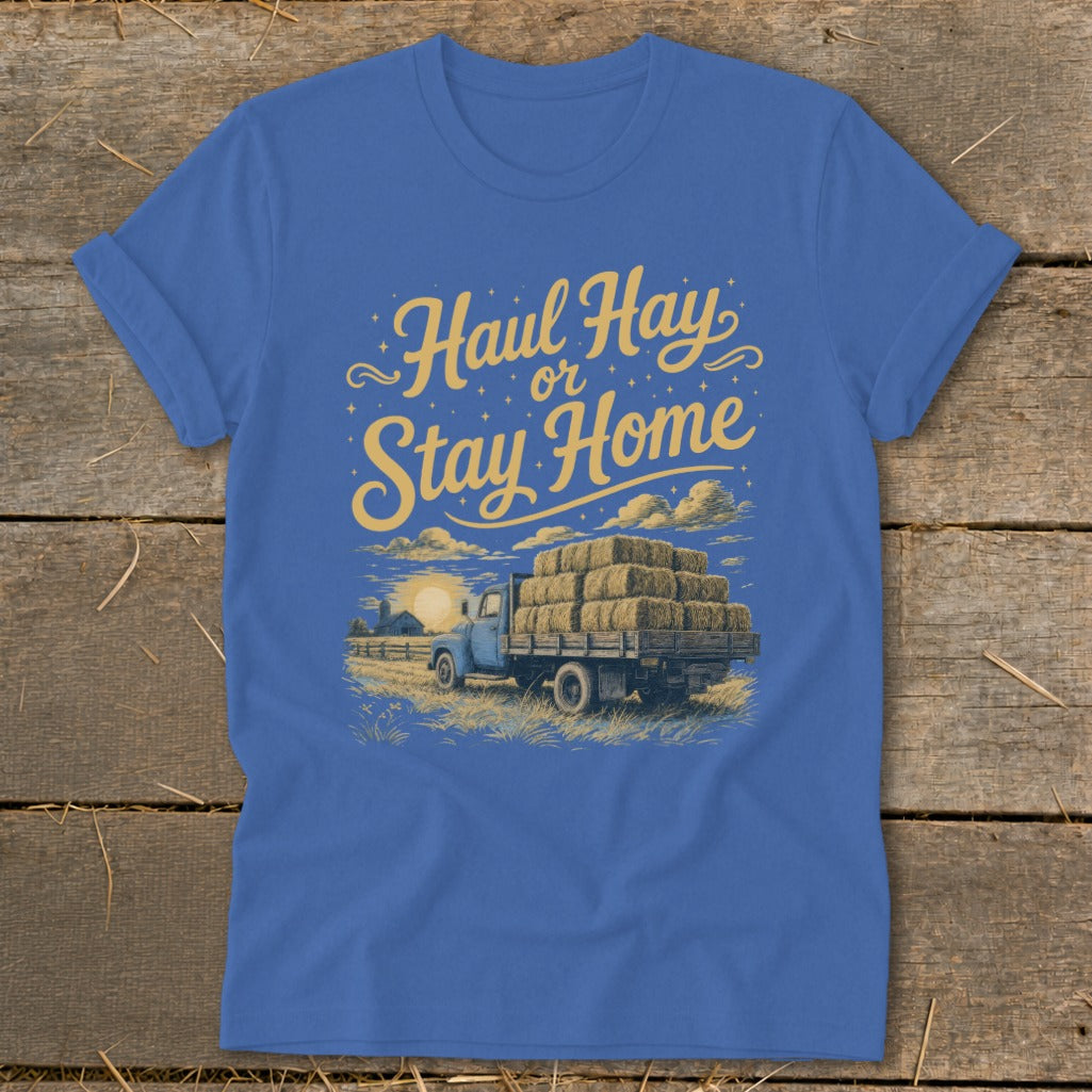 Blue t-shirt graphic with yellow text "Haul Hay or Stay Home" above a truck of hay bales.