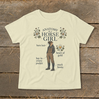"Anatomy of a Horse Girl" graphic tee with illustrated girl, barn hair, hay, and muck boots.