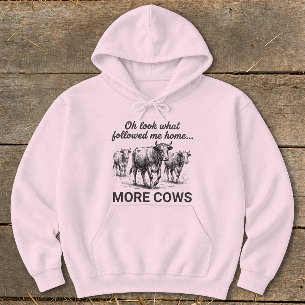 Pink hoodie with "Oh look what followed me home... MORE COWS" and a drawing of three cows.