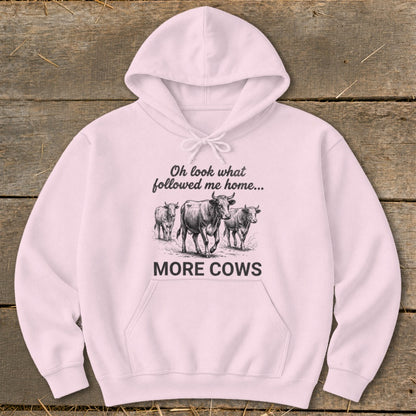 Pink hoodie with "Oh look what followed me home... MORE COWS" and a drawing of three cows.