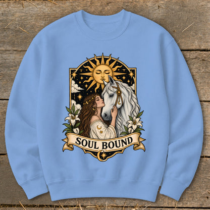Woman with brown hair nuzzles a white horse under a sun and starry sky.