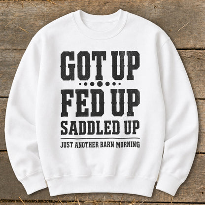 White sweatshirt with "GOT UP FED UP SADDLED UP JUST ANOTHER BARN MORNING" text.