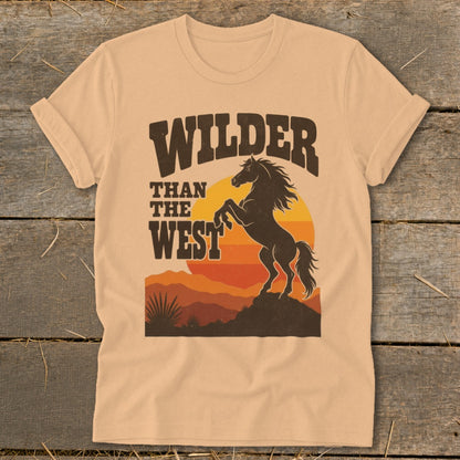 T-shirt graphic: "Wilder Than The West" text above a rearing horse at sunset.