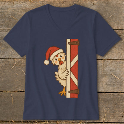 Cute chicken wearing a Santa hat peeks around a red barn door.