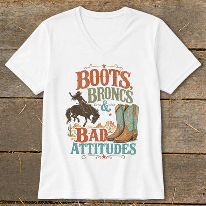 White t-shirt with "Boots, Broncs & Bad Attitudes" graphic and cowboy imagery.