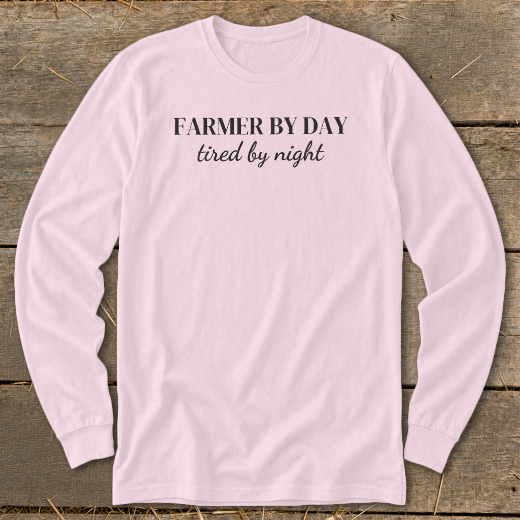 Pink long-sleeved shirt with "FARMER BY DAY tired by night" text.