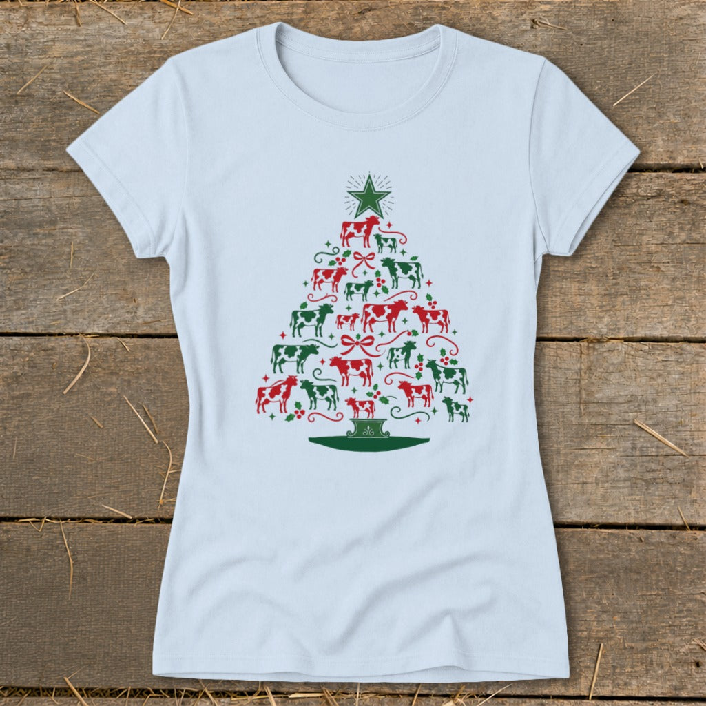 Light blue t-shirt with a Christmas tree design made of red and green cows and holly.