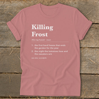 A dusty rose t-shirt features a humorous definition of killing frost printed in white text on the chest.